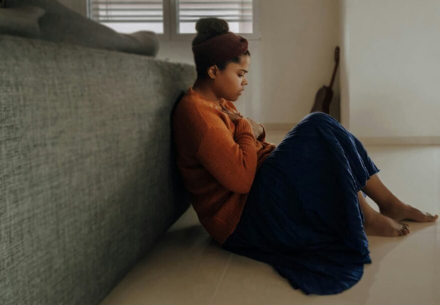 Une femme assise en pleine crise d'anxiété.